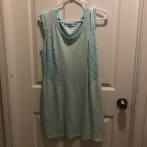Teal form fitting mini dress.